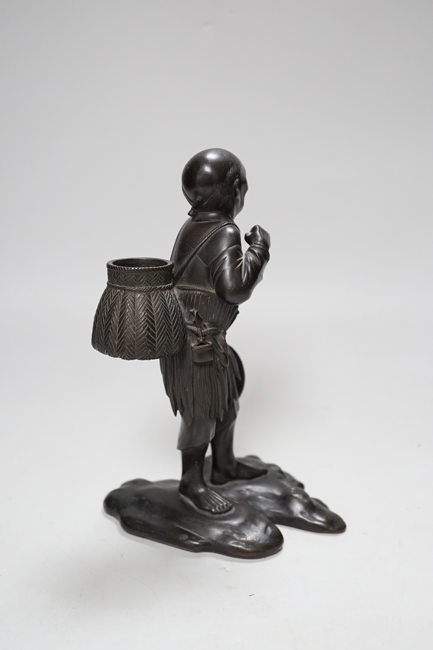 A Japanese bronze figure of an elder, 19th century, 23cm high